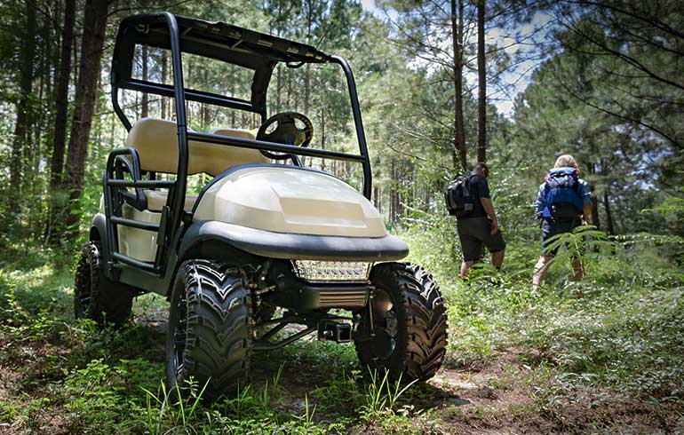 Golf Cart on trail in woods